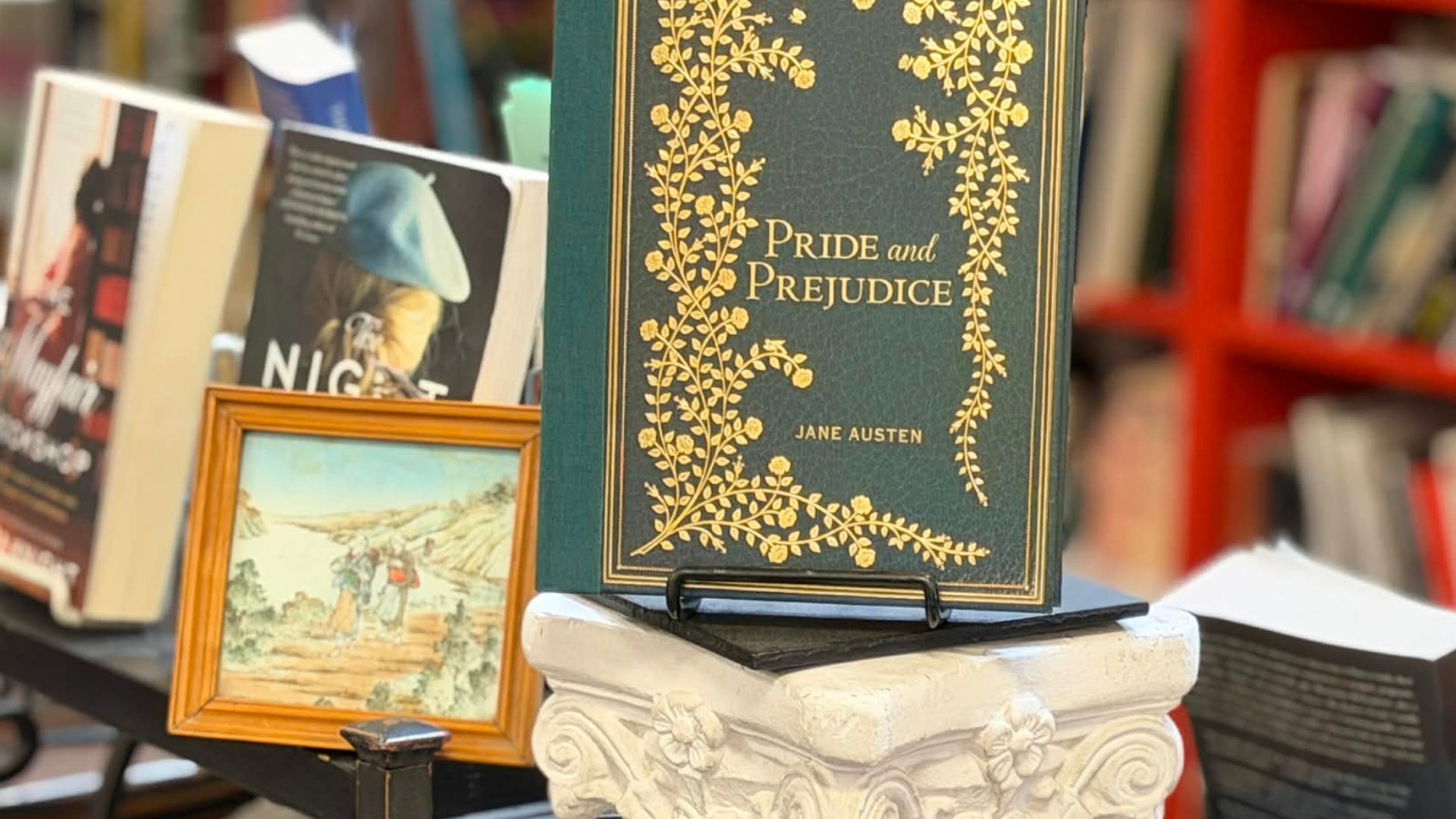 Book display with 'Pride and Prejudice' by Jane Austen and other books in a bookstore setting.